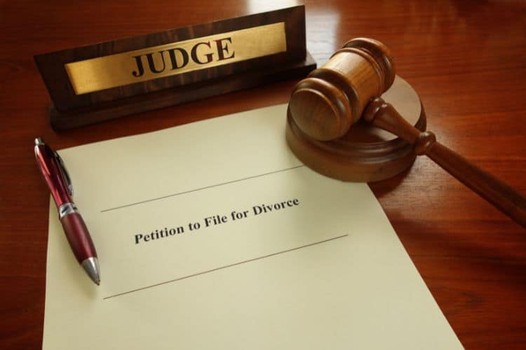 A petition to file fot divorce document, along with a judge's name tag and gavel