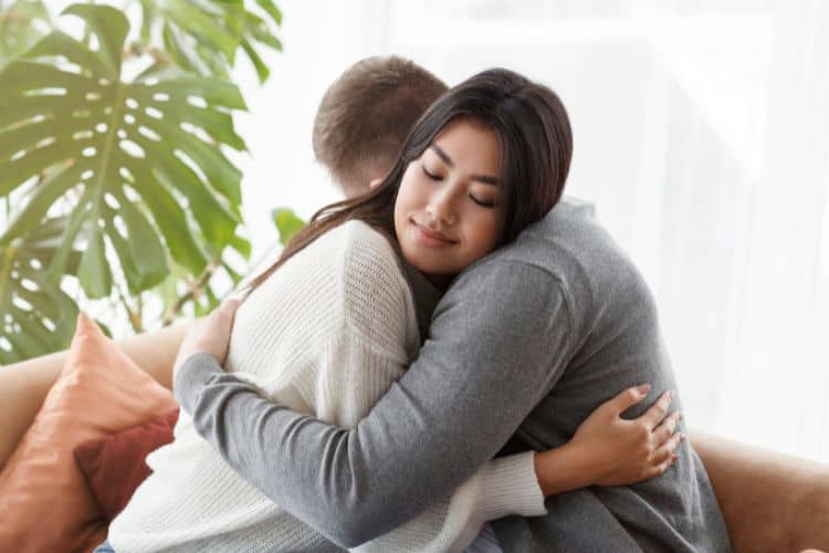 Loving Spouses Hugging on a Couch