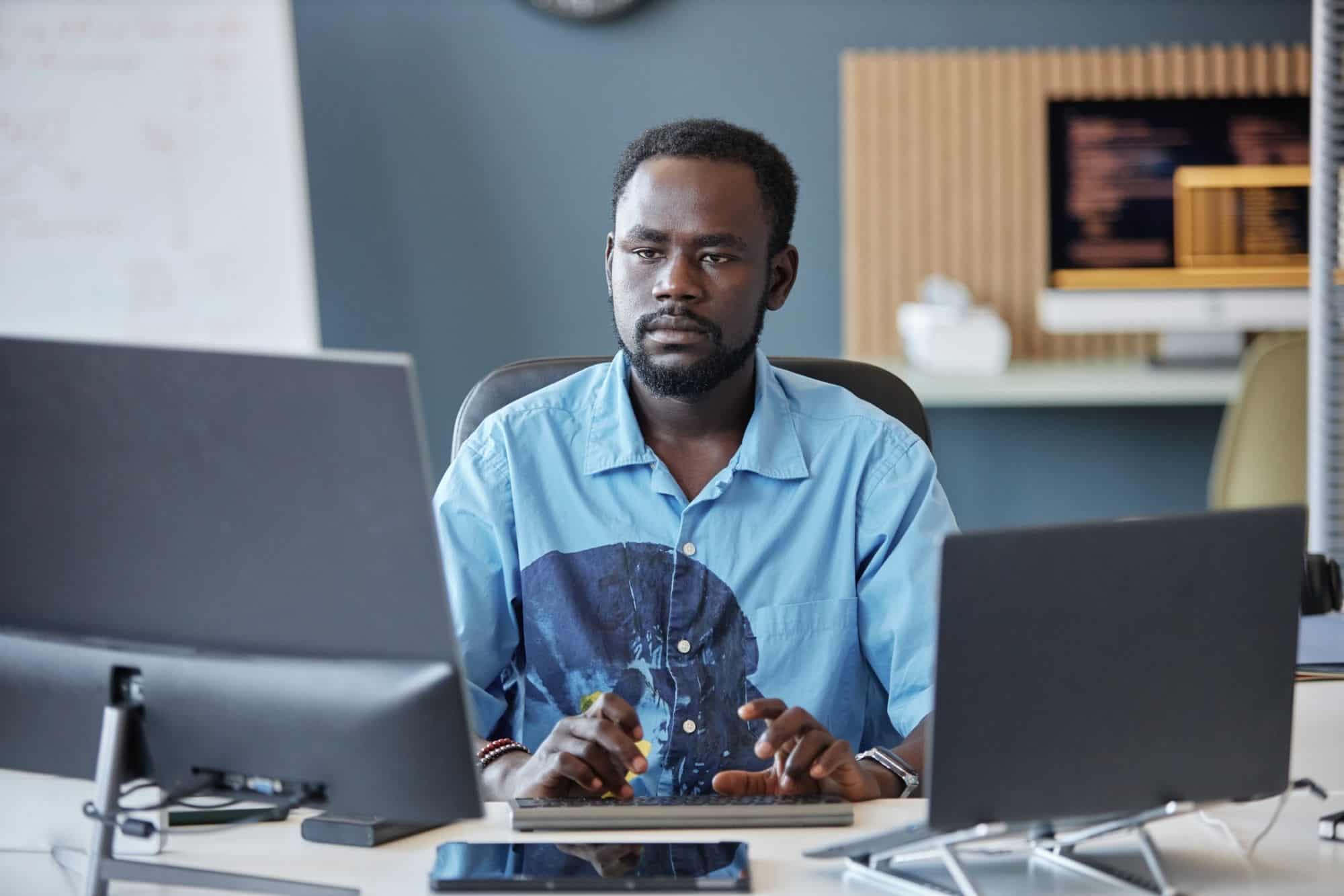 A man working calmly at a desk in a bright room, representing the strategic and quiet strength of different personality types.