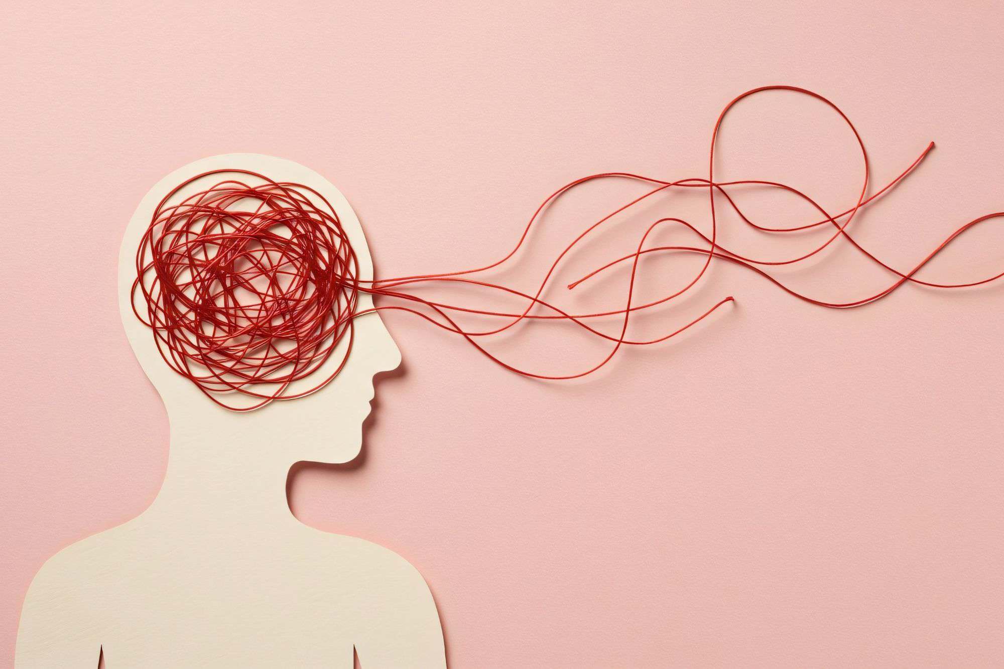 An artistic shot of tangled black yarn against a white background, symbolizing the complex web of unspoken expectations and silent scorekeeping.