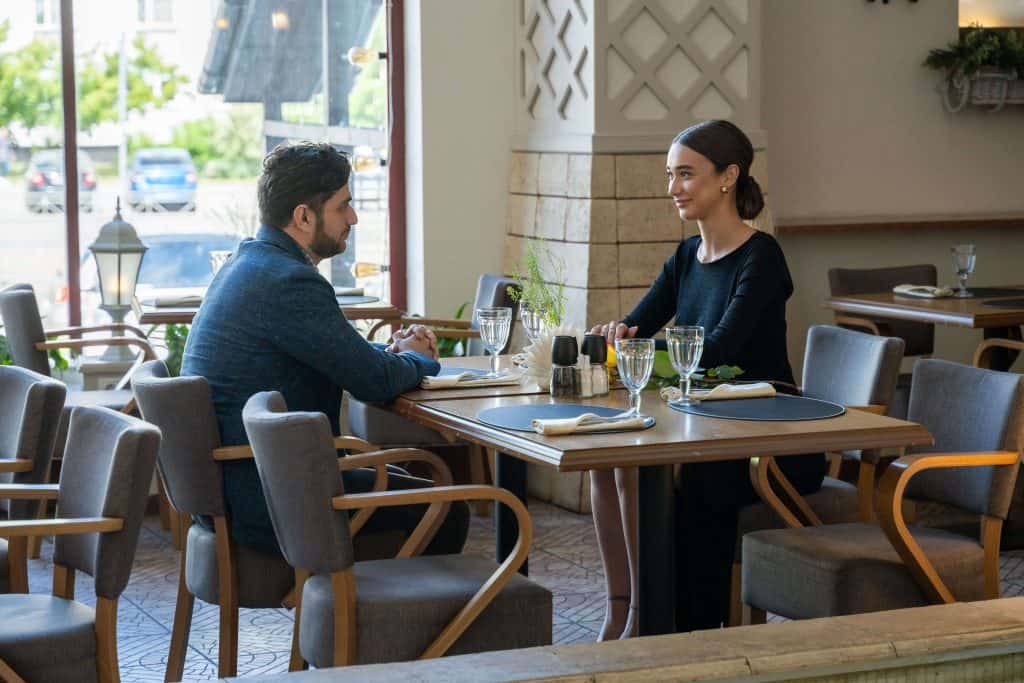 man and woman enjoying a drink at a cafe